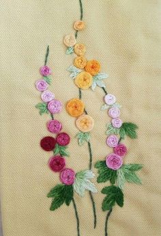 an embroidered piece of cloth with flowers on it