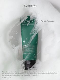 a tube of green facial cleanser sitting in foamy water on top of a white surface