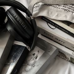 a pile of books and headphones sitting on top of each other