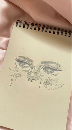 a drawing of a woman's face on top of a sheet of paper