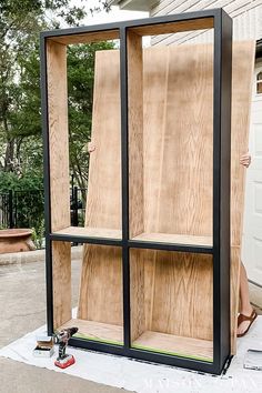 an outdoor storage unit made out of plywood