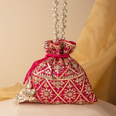 Beautiful Ethnic Kota Doria Gota Patti Embroidered Pink Potli Purse | Wedding India Drawstring Purse for Woman | Indian Gifting Purse Dimensions : 10 x 8 (in inches) Key Features: Embroidery art work This potli is good match with both Indian and western outfits and are superb for wedding and festive parties This would be best complement to your designer saree, lenhga or any other kind of dress This is the combination of traditional and modern embroidery work This is enough to keep your accessories and all needed essentials and it can be a best gift for any woman. We welcome wholesale queries and all feedbacks. Kundan Embroidered Fabric For Reception, Wedding Kundan Sets With Multicolor Embroidery, Transitional Multicolor Embroidered Fabric For Wedding, Eid Wedding Traditional Wear With Multicolor Embroidery, Bollywood Style Potli Bag For Reception, Wedding Lehenga With Motifs For Eid, Festival Reception Potli Bag With Zari Work, Zari Work Potli Bag For Festivals And Reception, Bollywood Style Potli Bag With Dori Work For Reception