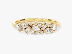 a yellow gold ring with three pear shaped diamonds