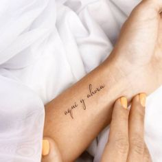 a woman's arm with a tattoo that reads, one day at a time