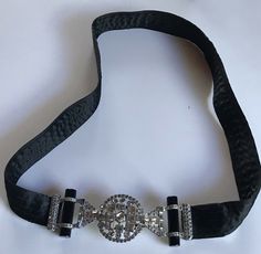 This wonderful vintage black satin belt from the 1930's measures approximately 30" (76.2 cm) in total length, 1" in width. The buckle is approximately 1-3/4" by 4-3/4" (4.5 x 12 cm). Good condition with some normal wear from use. Postage price includes insured shipping with delivery confirmation in the US, and insured international shipping to most countries. Always happy to combine shipping. Thanks!  El & Ned Elegant Adjustable Belt For Evening, Luxury Adjustable Belts For Evening, Luxury Adjustable Evening Belts, Adjustable Belt With Antique Buckle For Party, Vintage Adjustable Belt For Party, Vintage Adjustable Belts For Formal Wear, Adjustable Vintage Party Belt, Formal Black Belt With Antique Buckle, Elegant Black Belt With Antique Buckle