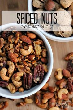 two bowls filled with nuts on top of a wooden table