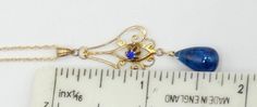 "Antique vintage 14k gold chain and 10k gold natural blue stone pendant necklace, In good antique vintage condition. Necklace 19\" long. Antique pendant circa 1910's. Pendant 1\" ¾ long ½ wide. Blue tear drop stone 10 mm x 6 mm. Weighs 2.5 gram. Marked 14k on the clasp. Thanks." Antique Blue Necklaces For Formal Occasions, 14k Gold Art Deco Birthstone Jewelry, Elegant Blue 14k Stamped Jewelry, Formal Blue 14k Gold Jewelry, Art Deco 14k Gold Birthstone Jewelry, Blue Gemstone Vintage Jewelry, Heirloom 14k Gold Blue Jewelry, Blue Art Deco Jewelry Stamped 14k, Victorian Style Blue Necklaces For Formal Occasions