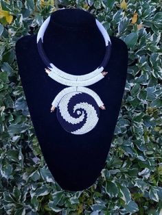 "This necklace is 100% handcrafted using white and black beads. Measurements: 18 inches around the neck. Pendant: 4\" Perfect for weddings, African themed events, traditional events etc. **Buy multiple items and pay shipping for 1 item only.The rest ships free. More neckleces here; https://www.etsy.com/shop/TribalTess?ref=seller-platform-mcnav&section_id=21306083 Back to my shop; https://www.etsy.com/shop/TribalTess?ref=seller-platform-mcnav" Neck Pendant, White Bead Necklace, Leather Beaded Necklace, Beautiful Beaded Necklaces, White Beaded Necklaces, Necklace African, African Necklace, Themed Events, Maasai