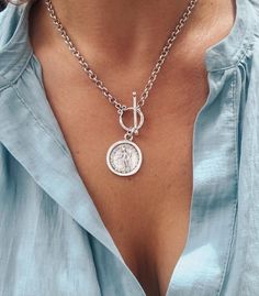 🌟 Bestseller 🌟 A stylish, lightweight edgy matte silver medallion style necklace. Perfect for layering with other chains.🗿Matte Silver, zamak rolo chain🗿 Matte Silver zamak Greek coin medallion (double sided) 25mm x 20mm🗿Large front facing toggle clasp🗿 Wear on it’s own or layer it up🗿 Choose your length 🌟 Zamak is that stylish matte silver metal favoured by European designers and has a distinctly bohemian character. It is a mix alloy of zinc, aluminium, magnesium and copper that is dipp Coin Necklace Silver, Chain Layering, Silver Coin Necklace, Toggle Necklace, Horn Pendant, Greek Style, Medallion Necklace, Fabulous Jewelry, Layering Necklace