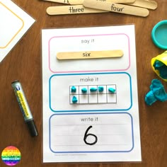 the number six worksheet is next to scissors, markers and pencils on a table