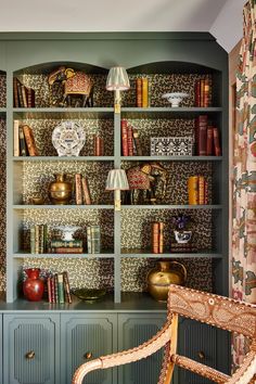 a green bookcase filled with lots of books