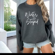 Cozy up with our 'Winter is Stupid' Sweatshirt, the perfect gift for your loved one who's not a fan of the cold. This sweatshirt isn't just warm; it's a lighthearted statement against winter's chill. Fight seasonal blues with humor, because who wouldn't want to bring back the sunshine? Gift comfort and a good laugh to combat the cold - a perfect remedy for seasonal grumbles. Gildan 18000. Ideal for any situation, a unisex heavy blend crewneck sweatshirt is pure comfort. These garments are made f Closet Addition, Teacher Wear, Cute Shirt Designs, Funny Shirts Women, Too Cold, Winter Sweatshirt, Gift For Wife, T Shirts With Sayings, Funny Shirt