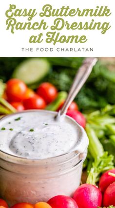 a bowl filled with ranch dressing surrounded by vegetables