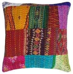 a multicolored patchwork pillow on a white background