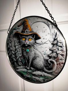 a glass plate with a cat wearing a witches hat on it's front door