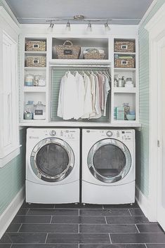 a washer and dryer in a laundry room with open shelving above them