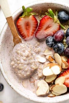 a bowl filled with oatmeal, fruit and nuts