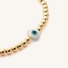 In many cultures, the Evil Eye is said to bring good luck and ward off misfortune. Whether worn for its cultural significance or simply for its beauty, this bracelet will stand out beautifully in your everyday stack. Pair it with our classic evil eye bracelet for extra luck. 14k Gold Fill 3 mm Genuine Mother-of-Pearl bead imported from Greece Sizing: 6.3" and stretches to 7". Please measure wrist prior to ordering, as we do not offer custom sizes. Gold Symbolic Bracelet With Evil Eye, Symbolic Gold Bracelets With Evil Eye, Spiritual Gold Bracelets With Evil Eye, Spiritual Evil Eye Bangle Jewelry, Spiritual Evil Eye Bracelet For Everyday, Gold Beaded Evil Eye Bangle Bracelet, Gold Beaded Bracelets With Evil Eye For Good Luck, Everyday Yellow Gold Evil Eye Bracelets, Evil Eye Bracelet For Everyday Wear