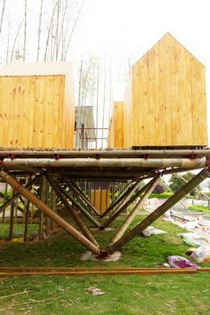 two wooden structures sitting on top of green grass