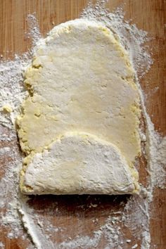 a wooden table topped with uncooked dough