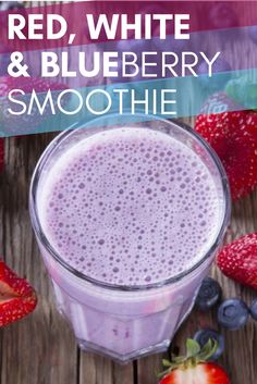 red, white and blueberry smoothie in a blender with strawberries on the side