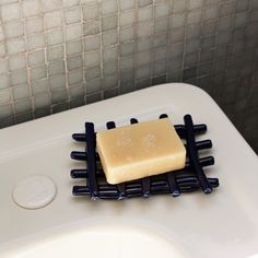 a soap bar sitting on top of a white sink