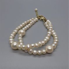 I don't typically make bracelets since they are so hard to make to "standard" wrist sizes. But I'm going to try and see if I can make bracelets that my customers like.  This bracelet is 7.5 inches long with a one inch gold filled extender chain.  These very luminous pearls are two sizes: 5mm and 10mm and the clasp is gold filled lobster claw.  My wrist is 6.5 inches and it fits me fine, also with extender chain if it needs to fit a larger wrist. Remember, all pearl surfaces are soft and may be likely to scratch if not careful. Adjustable Hypoallergenic Pearl Bracelet For Anniversary, Adjustable Round Gold Bracelet With Extender, Adjustable Gold Bracelet With Extender, Classic Adjustable Hypoallergenic Pearl Bracelet, Classic Adjustable Gold Bracelet With Lobster Clasp, Classic Adjustable Charm Bracelet With Round Beads, Classic Charm Bracelet With Adjustable Round Beads, Classic Adjustable Beaded Bracelets For Anniversary, Classic Charm Bracelet With Round Beads