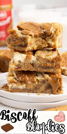 three pieces of biscuit blondies stacked on top of each other in front of a jar of peanut butter