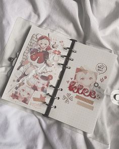 an open planner book on top of a bed