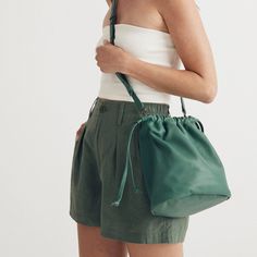 Welcome To The Piazza. Our Luxurious Bag Family Features Easy Shapes, Bold Colors And Supersoft, Sustainable Leather. With Its Cinched Drawstring And Back Pocket, This Bucket Bag Is Designed To Hold A Phone, Wallet, Pouch, The Works. The Best Part? It Can Be Carried Two Ways, Thanks To The Adjustable Shoulder Strap. Leather. Cinch Closure. 21 7/10" Handle Drop. 10 3/4"H X 9"W. Do Well: All Leather, Including Some Reclaimed From What Would Otherwise Be Waste, Was Sourced From A Tannery That Achie Green Pouch Bucket Bag With Adjustable Strap, Green Adjustable Strap Bucket Bag, Green Travel Bucket Bag With Detachable Handle, Green Everyday Pouch Box Bag, Hobo Bag With Removable Pouch For Errands, Green Everyday Box Bag Shaped As Pouch, Green Bucket Bag With Dust Bag For Travel, Green Travel Bucket Bag With Removable Pouch, Green Bucket Bag For Travel With Dust Bag