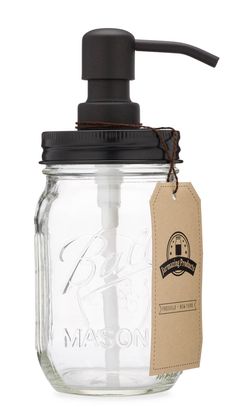 a mason jar with a soap dispenser attached to the top and a tag hanging from it