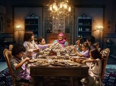 a group of people sitting around a table with food