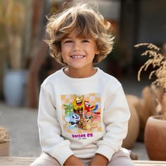 Hey there, cool kid (and awesome grown-ups Cartoon Friends)! Searching for that perfect combo of cozy and cute for your little rockstar? Look no further than our Amigos Cartoon Friends Youth Crewneck Sweatshirt!  Crafted to wrap your kiddos in ultimate softness while keeping their style game strong, this sweatshirt is like a warm hug from their favorite cartoon buddies! Just pop it on for instant smiles and non-stop comfort.  Perfectly snug, it's made for endless adventures, dreamy nap times, an Playful Cartoon Print Sweatshirt For Playtime, Playful White Sweatshirt With Character Print, Playful Cartoon Print Sweatshirt, Playful Graphic Print Sweatshirt For Playtime, Playful Graphic Print Sweatshirt, Cute Crew Neck Sweatshirt For Playtime, Playful White Sweater With Graphic Print, Casual White Sweatshirt For Playtime, Fun Graphic Tees