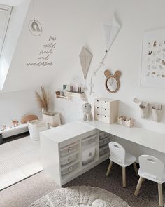 a child's room with white furniture and accessories