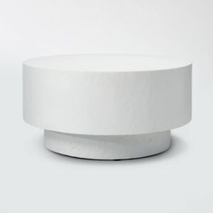 a white round table sitting on top of a white floor