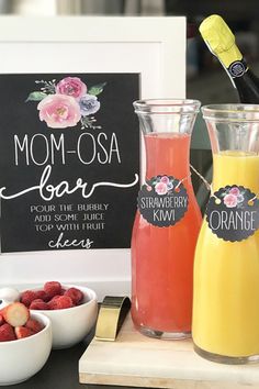 three different types of drinks are sitting on a table next to a sign that says mom - osa loar