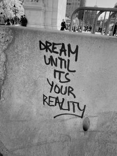 graffiti written on the side of a skateboard ramp that says dream until its your reality