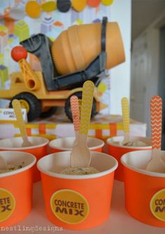 orange cups filled with ice cream and straws