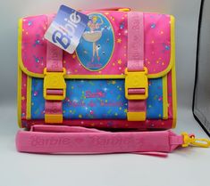 a pink, blue and yellow bag sitting on top of a table