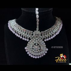 This bridal set is made up with rodium silver polish and gives up an excellent royal look. It comes with Choker, necklace, long haar, earrings, mathapati, Hath Panja, passa. For more designs or any query. Contact us : +91-9079290206 Traditional Formal American Diamond Sets, Traditional Silver Hand Set, Silver Temple Jewelry Sets For Festivals, Elegant Silver Tikka For Festive Occasions, Traditional Silver Hand-set, Elegant Silver Tikka For Festivals, Ceremonial Hand-set Bridal Sets, Hallmarked Chandbali Kundan Necklace For Wedding, Chandbali Kundan Wedding Necklace Hallmarked