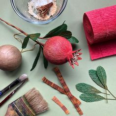 some art supplies are laying out on a green surface with paintbrushes and other items