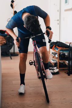 a man riding a bike in a room