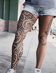 a person with tattoos on their legs and leg