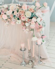 the wedding table is decorated with flowers and candles