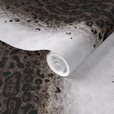 an animal print wallpaper with black and white spots on the fabric, which is very soft