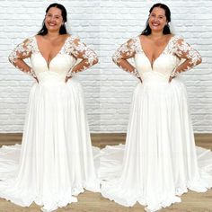 a woman standing in front of a brick wall wearing a white dress with long sleeves