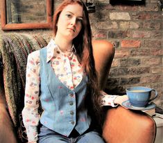 A one-off ladies' waistcoat in a denim style blue cotton with an embroidered heart motif. The back of the waistcoat is in a gorgeous 'patchwork' style cotton, with embroidery down the panels. The lining is a flower print polycotton.   This style of waistcoat has a seam at the bust and is quite generous. All my waistcoats are individually made and are unique, so you can create your own style.  Approximate measurements: Bust and around the back: 94 cm Nape to hem at the back: 46 cm Fitted Cotton Denim Vest Top, Fitted Denim Vest Top, Fitted Blue Denim Vest Top, Fitted Denim Blue Vest For Spring, Fitted Denim Blue Cotton Top, Fitted Patchwork Vest For Fall, Fitted Vintage Denim Top With Buttons, Fitted Patchwork Vest For Spring, Fitted Denim Cotton Vest For Spring