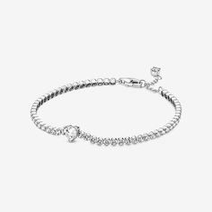 Bring elegance to your outfit with the Sparkling Pavé Tennis Bracelet. Hand-finished in sterling silver, this tennis bracelet is decorated with sparkling clear cubic zirconia. A large central heart-shaped stone punctuates a row of evenly sized pavé. The bracelet includes a lobster clasp for safe closure and can be adjusted to three lengths. Style it with other shimmering Pandora Timeless pieces for a classic look that stands out. - Pandora Sparkling Heart Tennis Bracelet - Sterling silver / Cubic Zirconia / Clear - Sz. 7.1 in Classic Silver Heart Bracelet With Cubic Zirconia, Classic Silver Cubic Zirconia Heart Bracelet, White Gold Heart Cut Tennis Bracelet, Heart Tennis Bracelet, Bracelet Tennis, Jewellery Uk, Carrier Bag, Pandora Bracelet, Pandora Jewelry