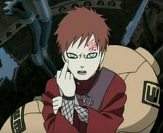 an anime character sitting in front of a ball with his hand on his face and looking at the camera