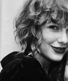 a black and white photo of a woman with curly hair